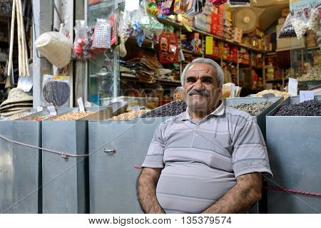 SHIRAZ - APRIL 14: Unknown man trades traditional iranian food in market (Vakil Bazaar) in Shiraz Iran on April 14 2015. Vakil Bazaar is the most important tourist attraction in Shiraz Iran.