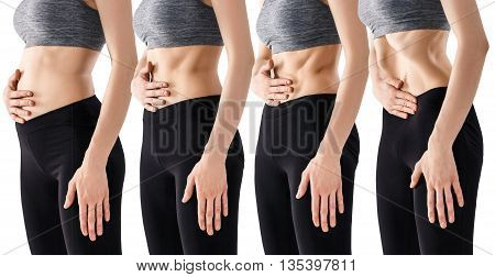 Sporty beautiful young woman practicing Uddiyana Bandha technique isolated on white