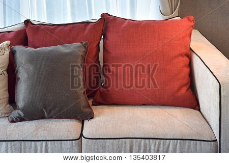 Red And Deep Brown Linin Pillows On Beige Linin Sofa In Modern Classic Living Room
