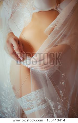 Sexy beautiful nude sexual bride with veil in white erotic lingerie