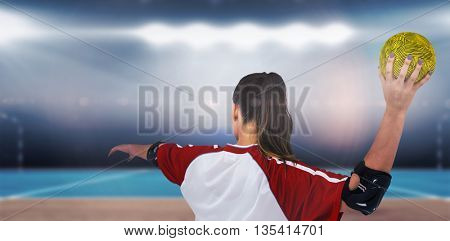 Sportswoman throwing a ball against digital image of handball field indoor