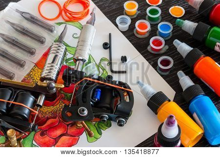 ink, two tattoo machines and accessories close up