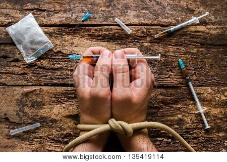 man holding syringe drug addiction close up