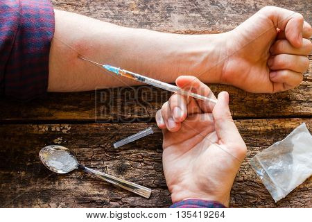 Male Drug Addict Injects Himself A Dose Of The Drug Selective Focus
