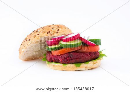 Vegan beetroot burger with lamb's lettuce, tomato, cucumber and radish isolated on white background