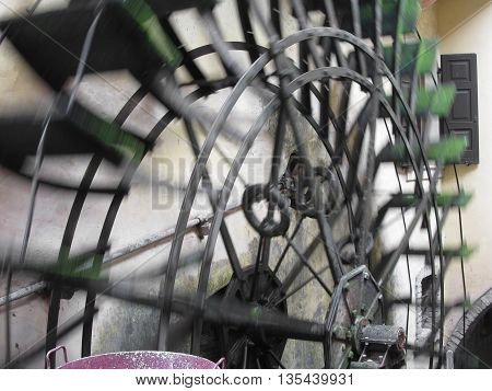 The rotary motion of the water wheel in an old historic watermill in italian village . Borghetto fraction of Valeggio sul Mincio (province of Verona) Italy