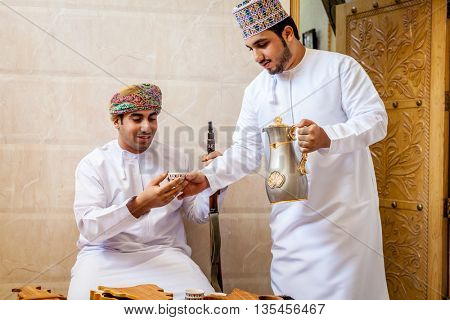 NIZWA, OMAN, MAY 27, 2016: two Omani men having traditional Omani coffee
