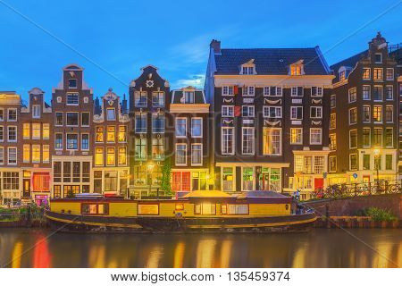 Amstel river, canals and night view of beautiful Amsterdam city. Netherlands