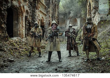 Nuclear post-apocalypse. Survivors in tatters and gas mask on the ruins of the destroyed city