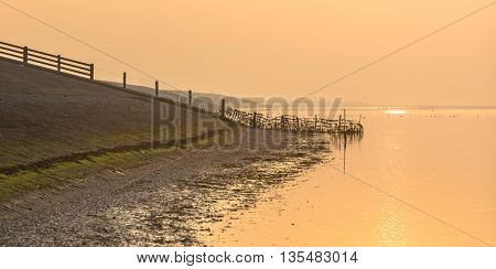 Sea Dike In Orange Haze