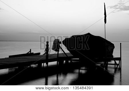 Docked boat a the cottage at dusk