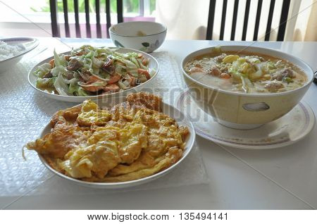 Thai Dinner setomeletfry vegetablesoup tofu on table