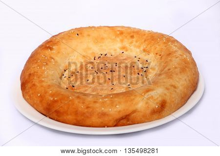 Tasty bread cake on the plate on white background