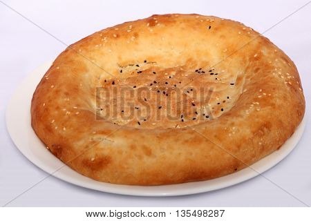 Tasty bread cake on the plate on white background