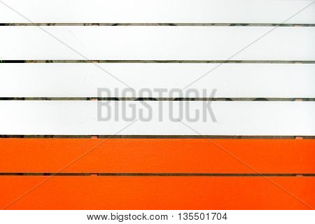 Wood painted in two colors sofe orange and white.