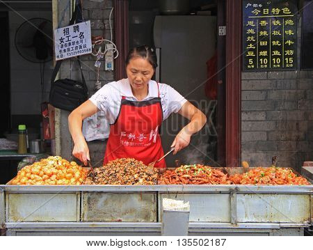 Wuhan, China - June 22, 2015:woman is selling snacks outdoor in Wuhan, China