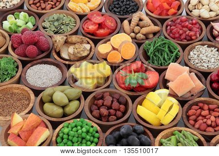 Healthy superfood selection in wooden bowls. High in antioxidants, vitamins, minerals and anthocyanins.