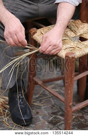 Mender Of Chairs While Repairing Old Wooden Chair