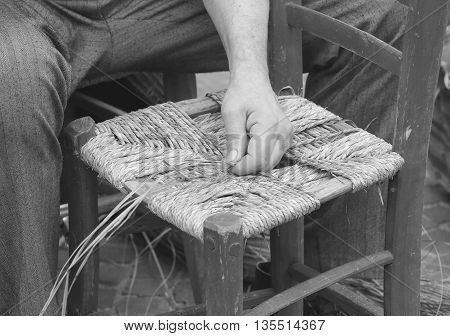 Mender Of Chairs While Repairing An Old Wooden Chair