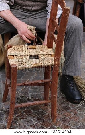 Hands Of A Mender Of Chairs While Repairing