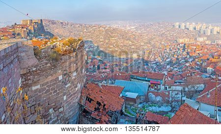 The old houses huddle close to the wall or share the common wall with the medieval citadel Ankara Turkey.