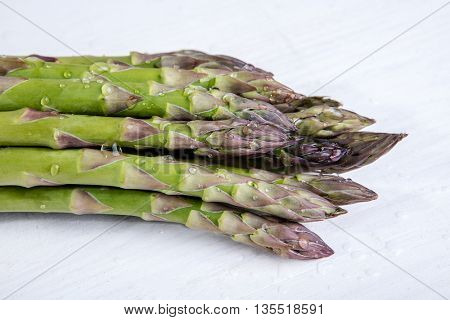 Green wet asparagus on the table
