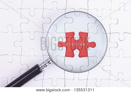 Business Concept - Magnifier Glass on white puzze with DISCOUNT Word
