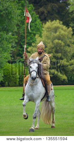 Silsoe, Bedfordshire, England - May 30, 2016:  A member of the Punjab Lancers in World War One uniform riding a white horse.