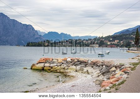 Yachtes in the bay near the city Castelletto on Lake Garda