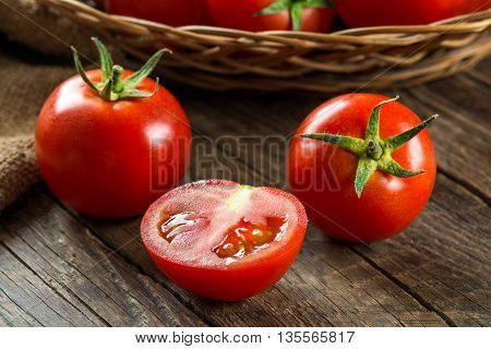 Ripe Tomatoes on wooden surface. Selective focus