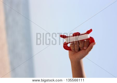 Boy flying a kite in a park with blue sky