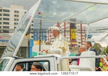 QUITO, ECUADOR - JULY 7, 2015: Pope Francisco saying hello to Ecuadorian people on Quitos street, stand up in his popemobile.