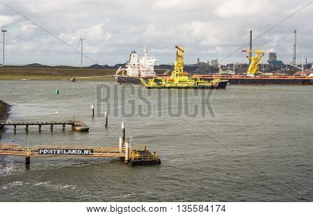 IJMUIDEN, NETHERLANDS - 15 SEPT. 2015: Coast guard ship in port of IJmuiden, the largest fishing port of the country. It is also port of departure for ferries and the location of steel factory Tata
