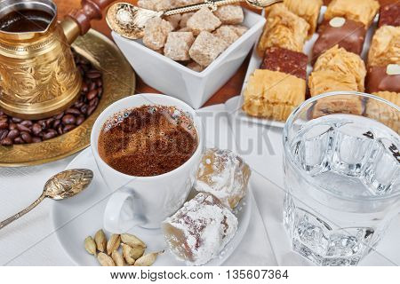 Traditional Turkish black coffee and sweet dainties