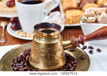 Traditional Turkish black coffee and sweet dainties