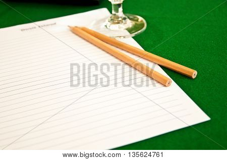 two wood pencil and paper in blackground green