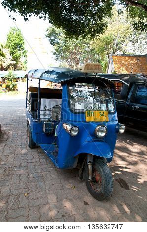A tuk tuk tricycle in temple at Thailand