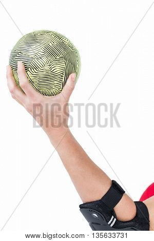Female athlete with elbow pad holding handball on white background