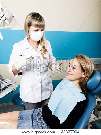 The reception was at the female dentist. Doctor examines the oral cavity on tooth decay. Caries protection. doctor puts the patient an anesthetic injection. close-up of the patient's mouth and squirt.
