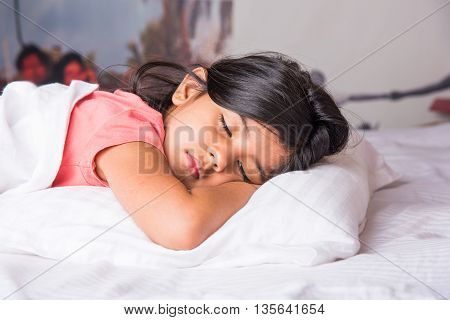 cute Indian Girl sleeping over white pillow, small asian girl sleeping on bed