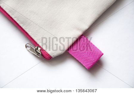 pink and white cloth handle bag on white background