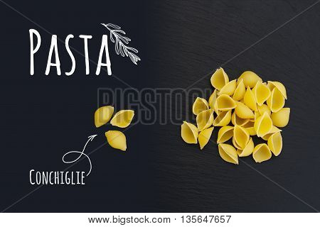 Uncooked Italian Pasta Conchiglie On Black Slate Stone Background