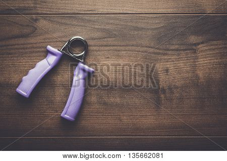 hand expander on the brown wooden table