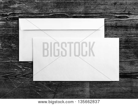 Blank envelopes on wooden background. Two envelopes. Back and front view. Mock-up for your design. For design portfolios. Top view.