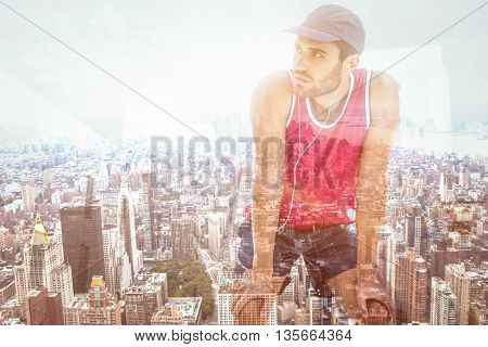 Exhausted athlete leaning forward after an effort against new york