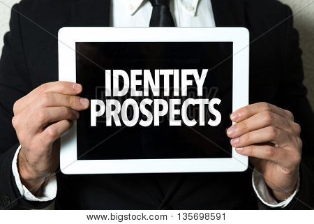 Business man holding tablet with the text: Identify Prospects
