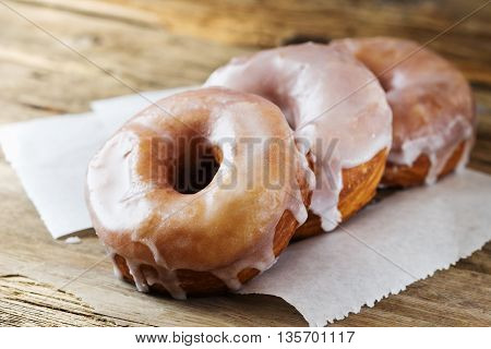 Fresh homemade donuts on a wooden table. Close-up. Toned image. Selective focus