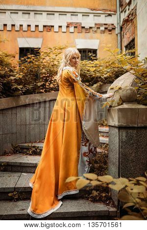 Beautiful lady with blond hairs in medieval dress