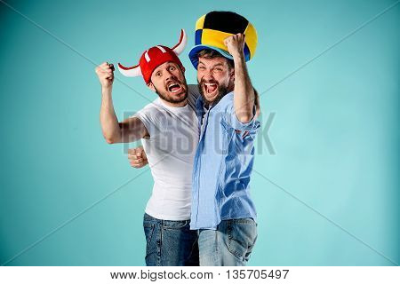 The two football fans over blue background