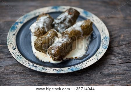 A plate with Romanian sarmale - stuffed vine leaves
